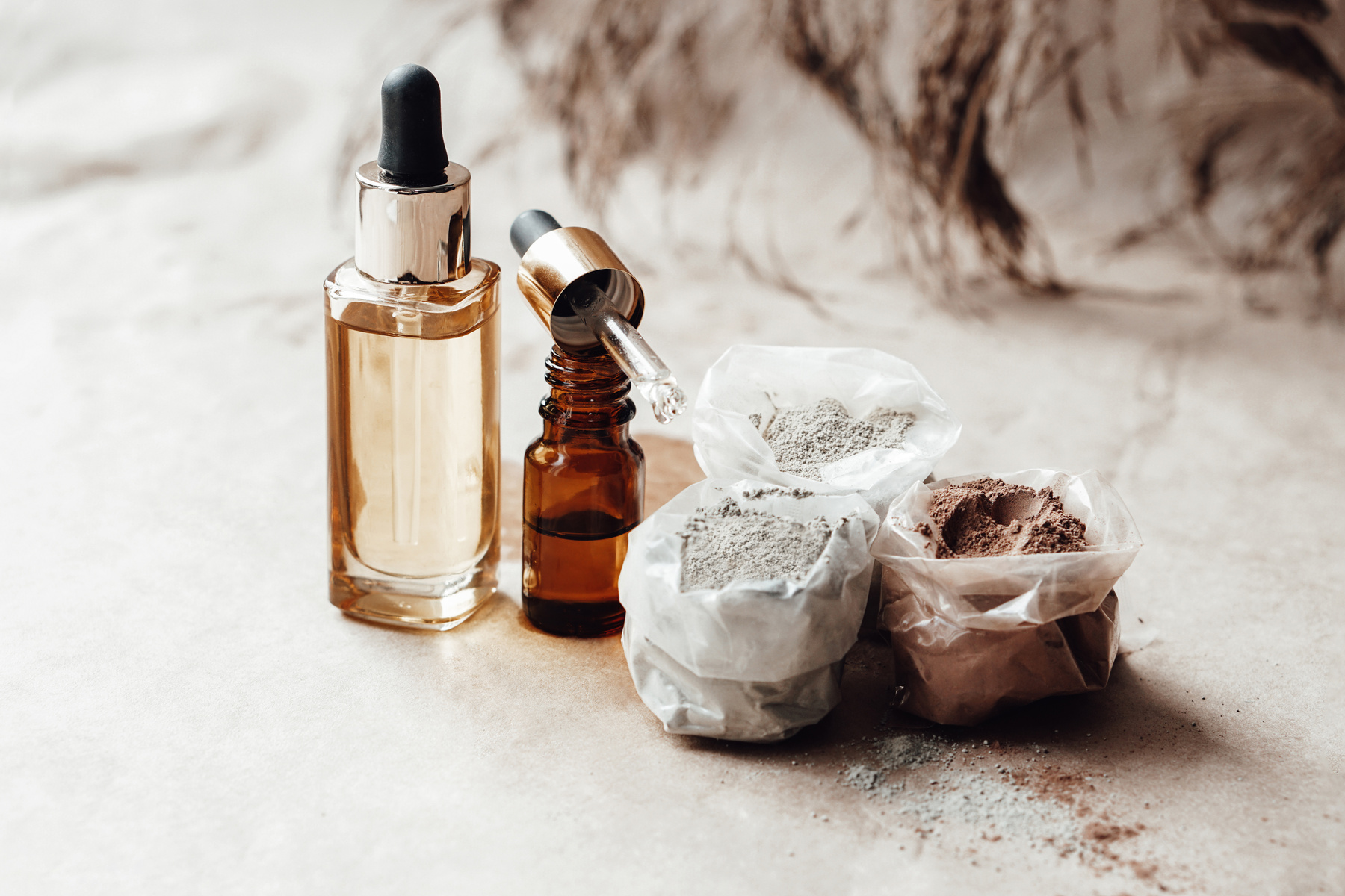 Glass bottle with cosmetic oil and cosmetic clay